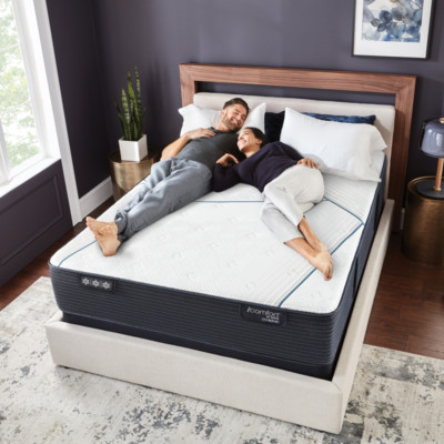 Family in bed relaxing after receiving their new mattress